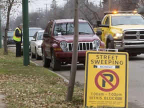 Saskatoon city council approved a 72-hour time limit for parking on residential streets on Monday, Feb. 25, 2019. In this October 2016 file photo, a towing company works with the city's parking enforcement to accommodate street sweeping operations.