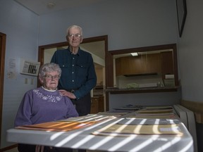 Tina and Ben Bueckert stand next to 14 files outlining the fraud that drained them of the majority of their life savings. On Jan. 31, David Matthew Adrian pleaded guilty to fraud over $5,000 and was sentenced to five years in prison.