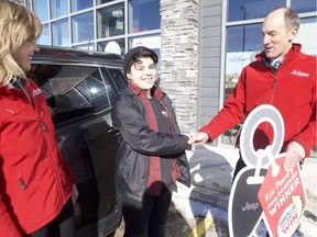 Kia Powery, a Saskatoon resident, can be seen receiving the keys to their brand-mew Jeep Compass on March 8, 2019 at the Tim Hortons on Preston Avenue with store owners Joni Seaman, left and Lou Gossner. Powery is the grand-prize winner of Tim Hortons' Roll up the Rim contest, winning one of 40 Jeep Compasses across Canada. They said they'll be looking to sell their 2002 Honda Civic, which just started exhibiting problems in the days before the big win, noting they plans to take some big road trips with their girlfriend and their two dogs in the new ride.