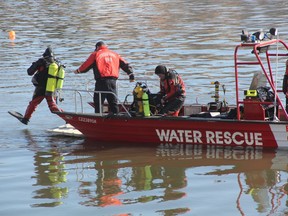 Members of the water rescue team enter the South Saskatchewan River near the Sid Buckwold Bridge after reports of a person in the water on March 13, 2019.