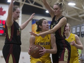 LeBoldus Golden Suns' Kamryn Maurer fights through some Centennial traffic during the high-school girls provincial 5A basketball final Saturday night.