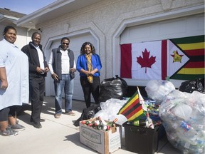Bottle drive- Elmo Gahamadze, Nyasia Mukura, Malone Chaya and  Blessing Madenga stand in from of collected bottles for  fundraiser/bottle drive to send money to the country following Cyclone Idai earlier this month. The group stands outside a home in Saskatoon, Sk on Thursday, March 28, 2019.