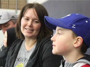 Ten-year-old Roan Dahlen looks towards the ice at the Canlan Ice Centre on March 22, 2019 as his parents Coralee Abbott and Mike Dahlen speak with the StarPhoenix about their efforts around Team Roan. The youngster, who has been diagnosed with Cancer, has been receiving a great deal of support from Saskatchewan's hockey community, with many players wearing gold laces as a sign of support for the young right wing.