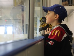 Ten-year-old Roan Dahlen looks towards the ice at the Canlan Ice Centre on March 22, 2019. The youngster, who has been diagnosed with Cancer, has been receiving a great deal of support from Saskatchewan's hockey community, with many players wearing gold laces as a sign of support for the young right wing.