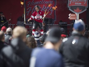 A performer tosses a flaming hockey stick during the Rogers hometown hockey event in Saskatoon, Sk on Sunday, March 31, 2019.