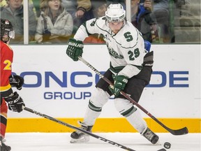 University of Saskatchewan Huskies forward Alex Forsberg moves the puck against the University of Calgary Dinos defence JamesÊShearer during second period U Sports hockey action at Merlis Belsher Place in Saskatoon on Friday, October 12, 2018.