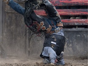 Cody Coverchuk lands upside-down after his bull, Rise Above, bucked him off at the Ranchman Renegades 17th Annual Bullbustin' Event at Ranchman's Cookhouse and Dancehall in Calgary, Alta., on Thursday, July 7, 2016.