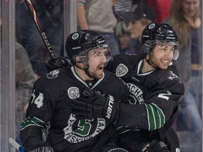 Logan McVeigh and Sam Ruopp celebrate the first goal for the University of Saskatchewan Huskies in a 6-1 victory Thursday over the University of Guelph Gryphons during University Cup national men's hockey championship quarterfinal action in Lethbridge. (MPP PHOTOGRAPHY)