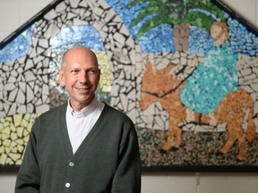 Roman Catholic archbishop of Regina Donald Bolen in front of a mural at the diocesan centre in Regina, Sask. on Monday July 11, 2016.