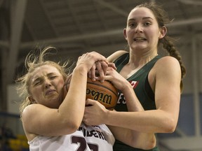 McMaster Marauders' Linnaea Harper, left, fights for a loose ball with University of Saskatchewan Huskies Megan Ahlstrom during U Sports Canadian women's basketball championship semifinal action, in Toronto on Saturday, March 9, 2019.