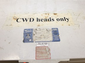 A sign on a freezer indicating it was being used for the storage of deer heads suspected of Chronic Wasting Disease, seen during a tour with Saskatchewan Conservation Officer Kerry Wrishko,  inside the SERM office Friday, Nov. 1, 2013.