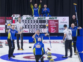 Team Alberta (in blue) celebrates Sunday's win at the Brier. Second Colton Flasch, left, and third B.J. Neufeld, far right, rejoice as lead Ben Hebert approaches triumpant skip Kevin Koe, whose back is to camera.