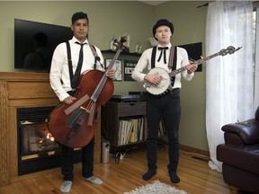 Danny Kenyon, left, plays cello and Colton Crawford plays banjo in The Dead South. They're pictured in Crawford's Regina home.