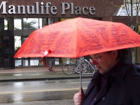 A pedestrian walks past the Manulife building in downtown Vancouver on May 3, 2012. Manulife Financial Corp. says a Saskatchewan court has ruled in its favour in the insurer's legal fight with hedge fund Mosten Investment LP over insurance contracts. The trial involving one of Manulife's insurance contracts purchased by Mosten wrapped up last year.