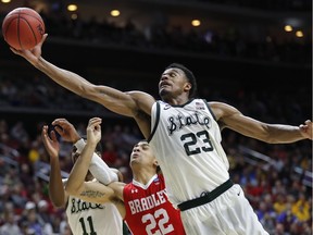 Michigan State forward Xavier Tillman (23) grabs a rebound over Bradley guard Ja'Shon Henry (22) during a first round men's college basketball game in the NCAA Tournament, Thursday, March 21, 2019, in Des Moines, Iowa.