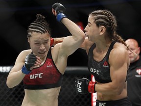 Tecia Torres hits Weili Zhang in a women's strawweight mixed martial arts bout at UFC 235, Saturday, March 2, 2019, in Las Vegas.