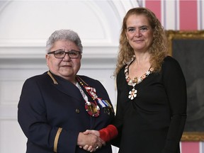 Marie-Anne Day Walker-Pelletier, left, of Okanese First Nation, Sask., the longest serving chief of Okanese First Nation, is invested by Governor General Julie Payette as a Member of the Order of Canada during a ceremony at Rideau Hall in Ottawa on Thursday, March 14, 2019.