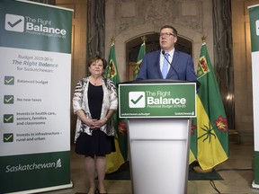 Finance Minister Donna Harpauer, left, and Premier Scott Moe speak to reporters after the tabling of the provincial budget.