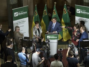 Finance Minister Donna Harpauer, left, and Premier Scott Moe speak to reporters after the provincial budget was announced in the Legislative Building in Regina on Wednesday.