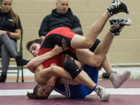 Noah Klitch, in blue, of Walter Murray Collegiate tosses Zakary Hamm of Warman High School during a male 56kg bout at the provincial high school wrestling championships held at Campbell Collegiate. Klitch won the bout. BRANDON HARDER/ Regina Leader-Post