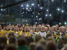 Family members and friends light candles during the Humboldt Broncos memorial service at Elgar Petersen Arena in Humboldt, SK on Saturday, April 6, 2019.