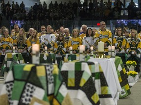 Family members and friends light candles during the Humboldt Broncos memorial service at Elgar Petersen Arena in Humboldt, SK on Saturday, April 6, 2019.