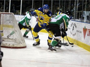 Saskatoon Blades' defencemen Brandon Schuldhaus battles with Prince Albert Raiders' forward Justin Nachbaur near the boards at the Art Hauser Centre in Prince Albert, Sask. on April 12, 2019. The Blades and the Raiders battled it out to see who would be headed to the next round of the WHL playoffs on Friday night in a series that has been a tug of war between the two WHL clubs. (Prince Albert Daily Herald/Lucas Punkari photo)