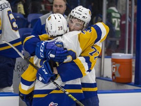 Saskatoon Blades forward Riley McKay,  left, and forward Kirby Dach hug after losing the game and series to the Prince Albert Raiders in WHL playoff action at SaskTel Centre in Saskatoon, SK on Sunday, April 14, 2019.