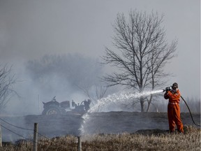 SASKATOON, SK--APRIL 16/2019-0417 News Brush Fire- Members of the Saskatoon Fire Department battle a large brush fire along Strathcona Avenue near Cranberry Flats outside of Saskatoon, SK on Tuesday, April 16, 2019.
