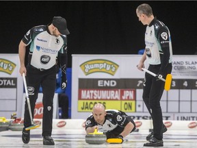 Ryan Fry, third for OntarioÕs Brad Jacobs (not pictured) throws as lead Ryan Harden, left, and second E.J. Harden prepare to sweep against JapanÕs Yuta Matsumura (not pictured) during the HumptyÕs Champions Cup at Merlis Belsher Place in Saskatoon, SK on Tuesday, April 23, 2019.
