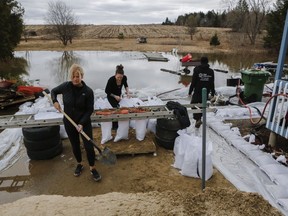 A military jeep moves through floodwaters on a closed street in Gatineau on April 23.