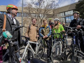 Dr. John Dosman  Hudson Walters, Luca Veenan, and Lauren Sarauer (left to right) lead group of cyclists in a chant.  Cyclists gathered for a rally in front of City Hall before a city council meeting to decide the fate of Saskatoon's bike lanes in Saskatoon, SK on Monday, April 29, 2019.