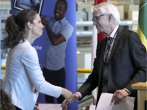 Federal Minister of Science and Sport Kirsty Duncan shakes hands with U of S President Peter Stoicheff at the Canadian Light Source ahead of a funding announcement in Saskatoon.