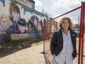 Artist Denyse Klett, who painted the mural of childrenÕs faces on the side of the Broadway Roastery, called So Much to Discover, stands for a photograph outside of the coffee shop on Broadway Avenue in Saskatoon, SK on Tuesday, April 30, 2019. The mural is going to be covered up by a new condo development after being visible for over 25 years.