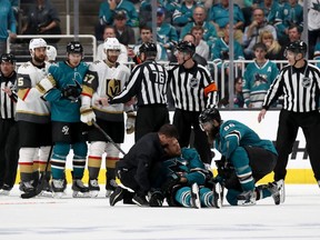 Joe Pavelski #8 of the San Jose Sharks is looked on after a hard hit by the Vegas Golden Knights in the third period in Game Seven of the Western Conference First Round during the 2019 NHL Stanley Cup Playoffs at SAP Center on April 23, 2019 in San Jose, California.