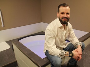 Jonathan Daku, the owner of  Theta Wave Float and Wellness, can be seen next to one of his open-air float tanks on March 26, 2019. Designing and constructing the space from the floor up, Daku said his business was designed to make people feel relaxed throughout the duration of their visit.