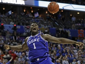 In this March 15, 2019, file photo, Duke's Zion Williamson (1) reacts after a dunk against North Carolina in Charlotte, N.C.