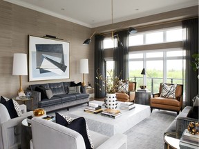 The living room is bordered by large windows which give the space its remarkable views of mature trees and the changing seasons. The living room is anchored by a large white marble coffee table and completed with neutral tones and gold accents.