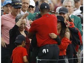 Tiger Woods hugs his family after winning the Masters golf tournament Sunday, April 14, 2019, in Augusta, Ga.