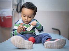 In this April 2019 photo provided by the St. Jude Children's Research Hospital, 2-year-old Gael Jesus Pino Alva plays with toys at the hospital in Memphis. Gael was one of eight babies with "bubble boy disease" who have had it corrected by gene therapy that ironically was made from one of the immune system's worst enemies _ HIV, the virus that causes AIDS. (Peter Barta/St. Jude Children's Research Hospital via AP) ORG XMIT: NY355