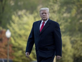 FILE - In this Monday, April 15, 2019 file photo, President Donald Trump walks on the South Lawn as he arrives at the White House in Washington, after visiting Minnesota. A U.S. judge in Oregon said Tuesday, April 23, 2019, he intends to at least partially block a rule change by Trump's administration that could cut off federal funding for providers who refer patients for an abortion, though the scope of his decision remains to be seen.