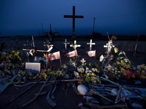 A memorial made of hockey sticks, crosses and Canadian flags is seen at the crash site of the Humboldt Broncos hockey team near Tisdale, Sask., Friday, August, 24, 2018. A year of dealing with lives lost and futures erased won't come to an end on April 6 - the first anniversary of the Humboldt Broncos bus crash. The Broncos were on their way to a playoff game in Nipawin, Sask. that day when their bus and a semi-trailer collided at a rural intersection. Sixteen people, including 10 players, died and 13 were injured.