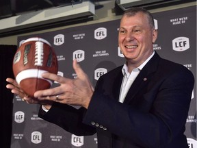 Randy Ambrosie tosses a football as he speaks during a press conference in Toronto on July 5, 2017. The CFL commissioner said Friday he'll be meeting football officials from Germany later this month to discuss the possibility of Canadian and German players suiting up in the respective circuits.