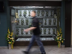 An attendee to the Humboldt Broncos Memorial service walks past a display at Elgar Petersen Arena in Humboldt , Saturday, April, 6, 2019.