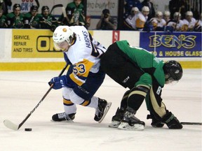 PRINCE ALBERT - Saskatoon Blades forward Ryan Hughes skates past Prince Albert Raiders defenceman Brayden Pachal during Game 2 of their Western Hockey League playoff series Sunday night.