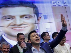 In this photo taken on Sunday, April 21, 2019, Ukrainian comedian and presidential candidate Volodymyr Zelenskiy gestures while speaking at his headquarters after the second round of presidential elections in Kiev, Ukraine. For his presidential campaign popular Ukrainian comedian Volodymyr Zelenskiy has literally taken the script from a TV show in which he plays the Ukrainian president.