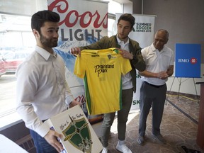 Jacob Powell, vice captain with the Saskatchewan Selects, stands with fellow vice captain Jordan (Chico) Farahani, with one of the two Select coaches, Percy Hoff as they unveil the team's new jerseys for the upcoming SK Summer Soccer Series on May 1, 2019. The first game of the series is set to take place on May 4, 2019 and officials say the game is already approaching a sellout.