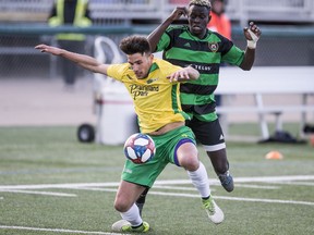 SASKATOON,SK--MAY 4/2019-*0506 Sports Selects - Saskatchewan Selects centre back Jordian "Chico" Farahani takes a foul from Calgary Foothills forward Moses Danto in the Saskatchewan Summer Soccer Series in Saskatoon, SK on Friday, May 4 2019.