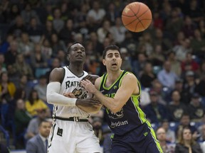 Saskatchewan Rattlers' guard Alex Campbell eyes the ball alongside Niagara Lions Nem Mitrovic during the Canadian Elite Basketball League opener last week at SaskTel Centre.