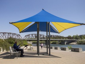 People take in the heat along the walkway at River Landing in Saskatoon, SK on Wednesday, May 29, 2019.